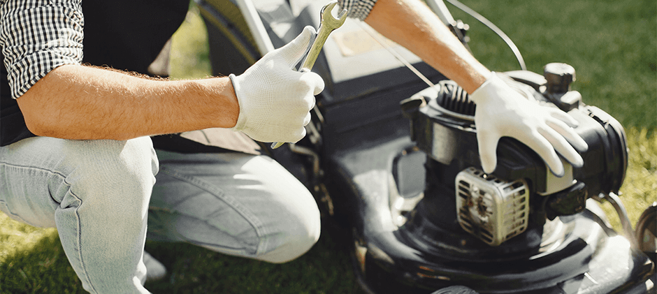 a man is repairing a lawn mower with confidence
