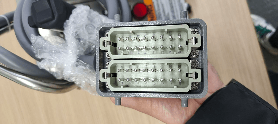 A close-up photo or 3D rendering of the 8-pin male connector of the elevator control box showing the pins clearly