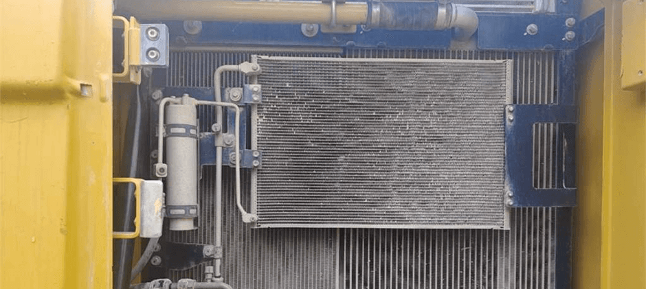 The radiator under the hood of heavy equipment