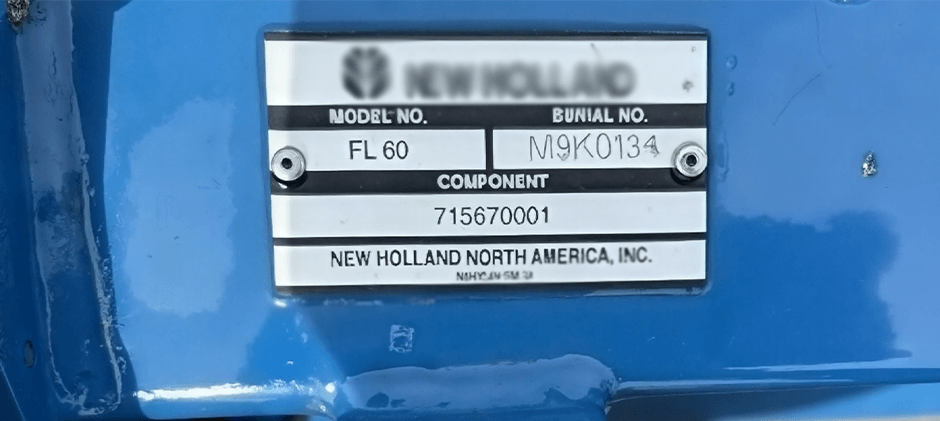 A close-up of a New Holland tractor's metal data plate, clearly showing the fields for Model No. and Serial No., which are essential for identifying the machine to order correct aftermarket parts.