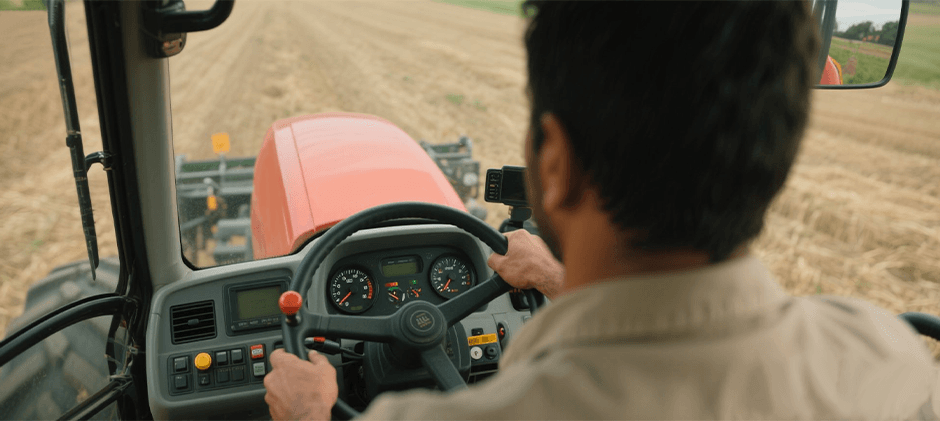 A-person-is-operating-the-equipment-inside-the-cab-of-Kubota's-tractor.