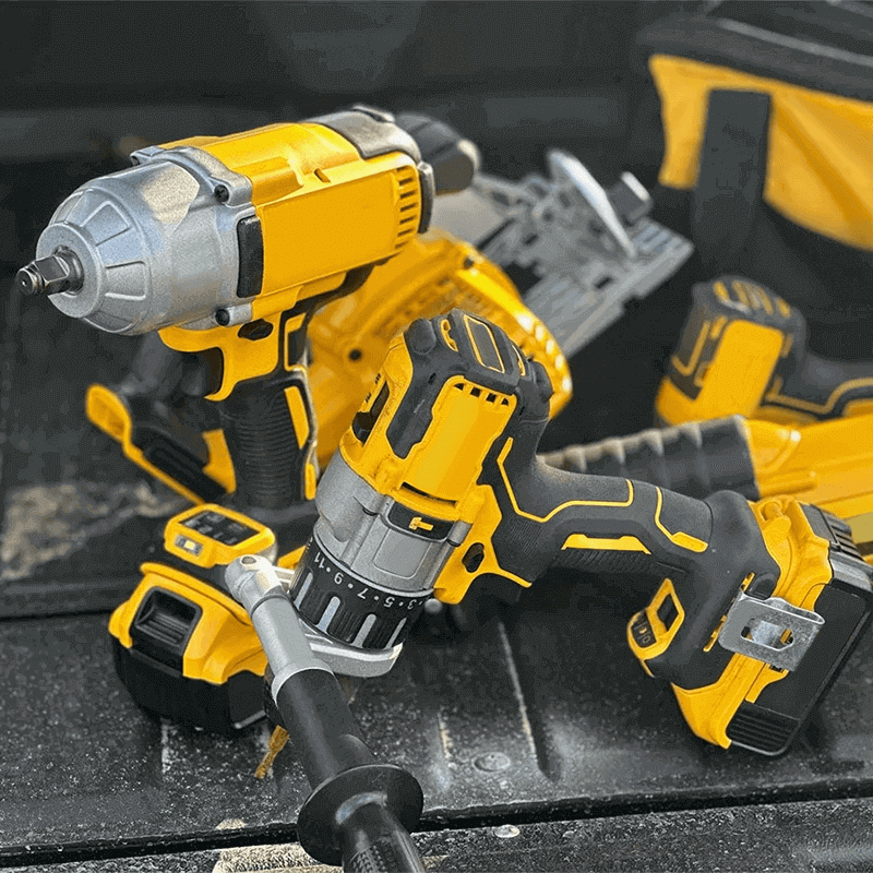 Essential Cordless Power Tools for High-Speed Tasks A set of yellow and black cordless power tools, including an impact wrench and a drill, sitting on the tailgate of a truck ready for a repair job.