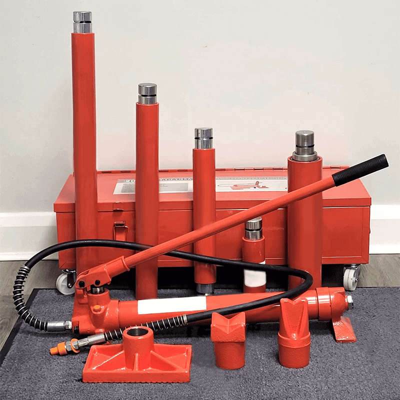 Hydraulic Porta Power Kit for Heavy-Duty Lifting and Bending A complete red Porta Power hydraulic kit with a pump, hose, and various ram attachments laid out in front of its metal toolbox.