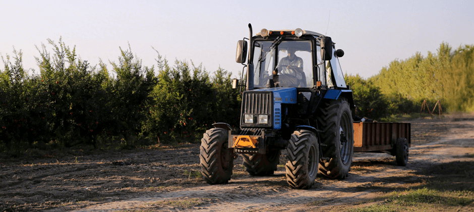 A person is driving a tractor.