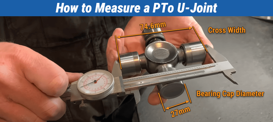 Person measuring a PTO U‑joint with a caliper showing cross width 74.6 mm and bearing cap 27 mm.