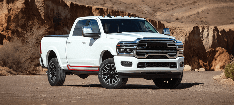 A white pickup truck parked in a desert, showing the location of the rocker panel along the lower body between the front and rear wheels.
