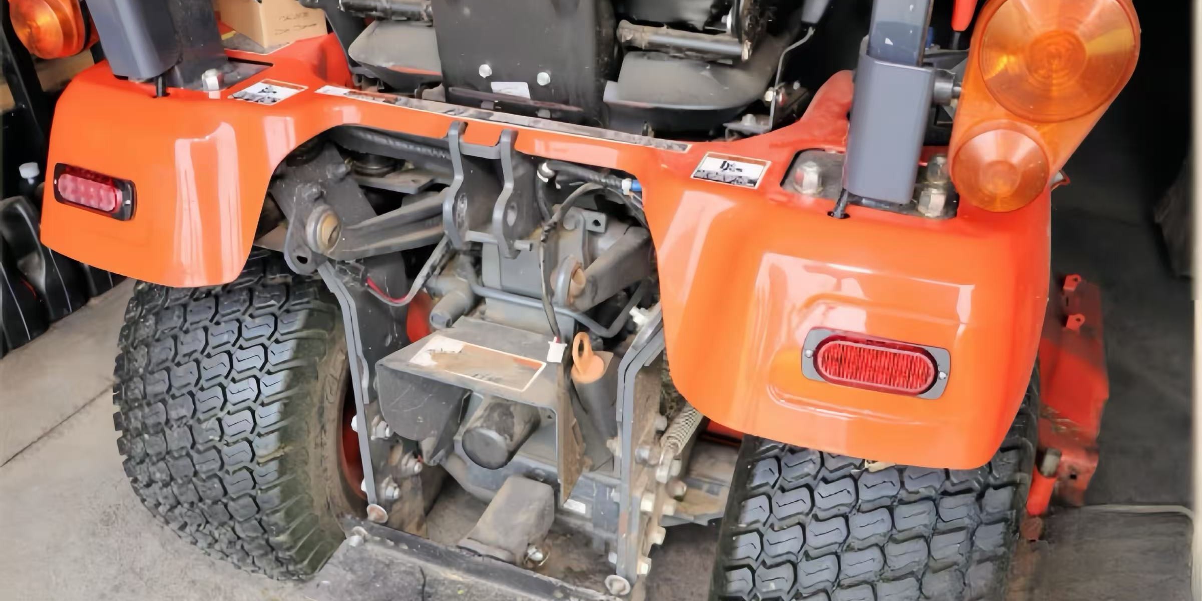 Orange off-road machinery showing tail light assemblies. Guide to replacing tail light bulbs on heavy equipment.