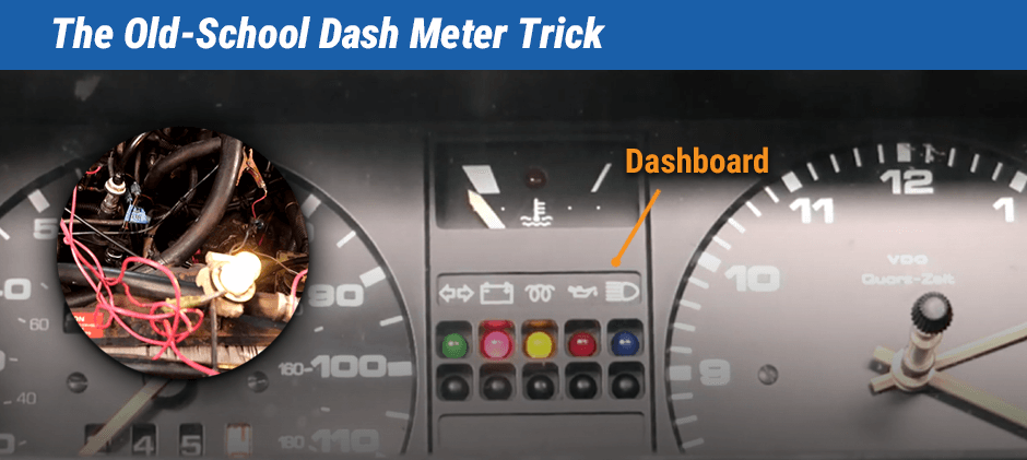 An old-school car dashboard with a circular inset showing a temporary light bulb wired into the engine, illustrating a diagnostic trick for older vehicles.
