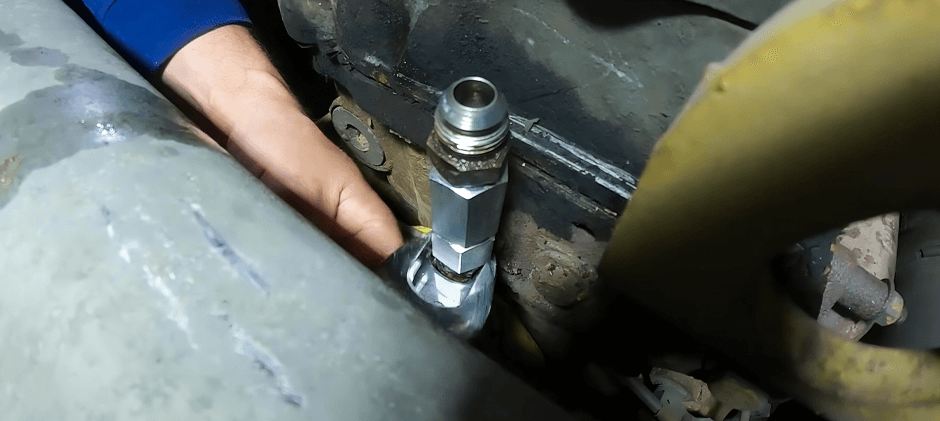 A person is repairing the fuel pressure regulator.