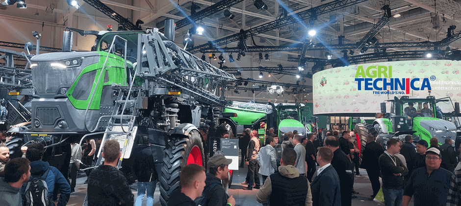 A wide view of the bustling Agritechnica exhibition hall, filled with visitors exploring advanced agricultural machinery and new technology.