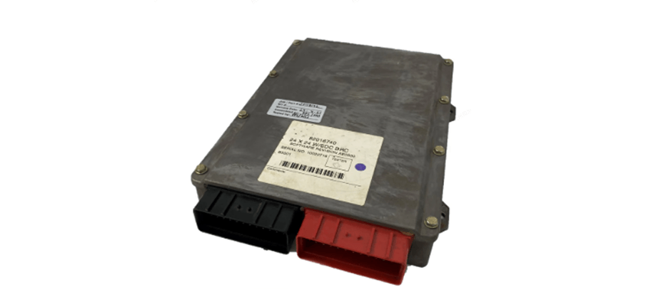 An isolated image of a heavy equipment transmission control module (TCM) with its black and red electrical connectors visible.
