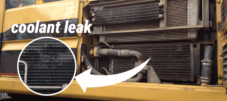 Close-up of a heavy machine's radiator, a common source of a coolant leak, with a magnified view of the fins.