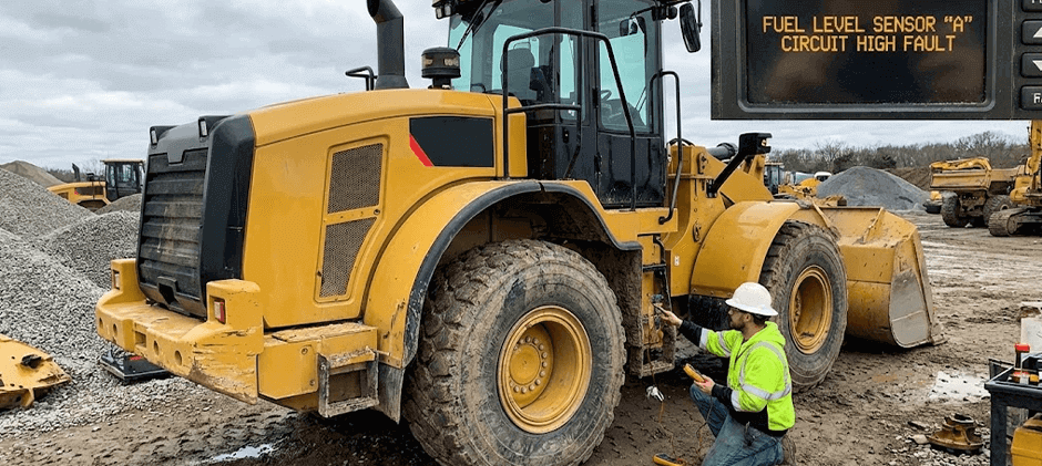 A technician diagnosing a wheel loader, with an inset showing the dashboard error message 'Fuel Level Sensor A Circuit High Fault'.