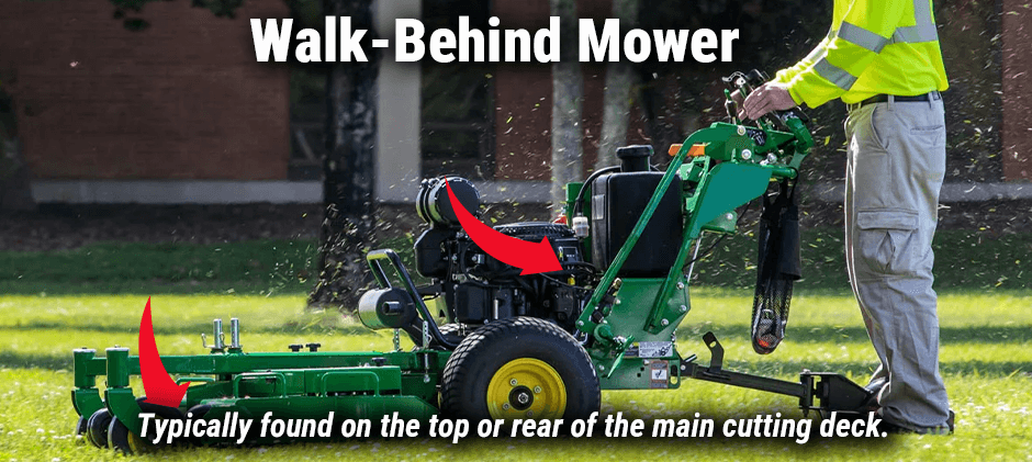 A person using a green commercial walk-behind mower, with arrows pointing to the main cutting deck where the serial number is usually located.