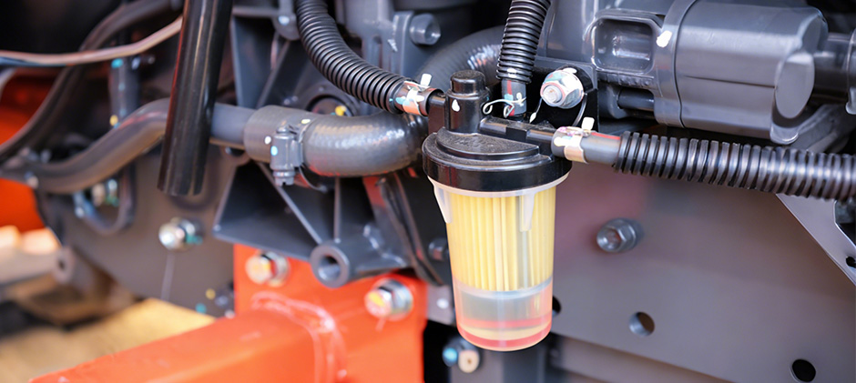 A clean, new diesel fuel filter and water separator assembly on a modern engine.