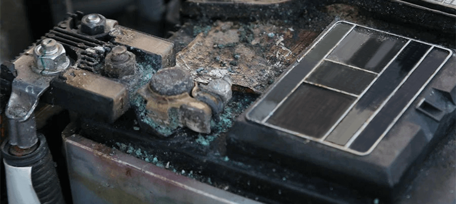 Both positive and negative battery terminals showing blue and white corrosion, indicating potential overcharging and undercharging issues.