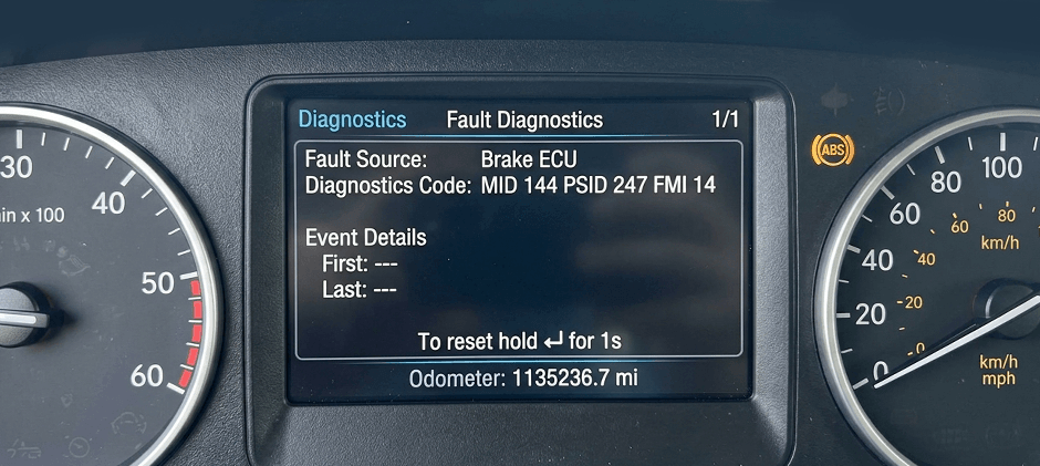 The digital diagnostic screen on a heavy machinery dashboard displaying a fault code: mid 144 psid 247 fmi 14.
