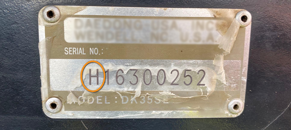 A close-up of a Kioti serial number where the first letter, 'H', is circled to show how to identify the year code.