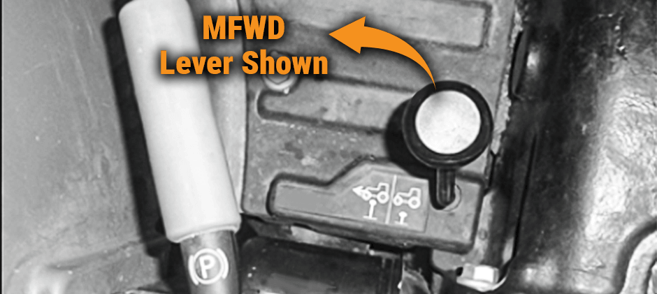 Close-up of an MFWD (Mechanical Front Wheel Drive) engagement lever inside a tractor cab.