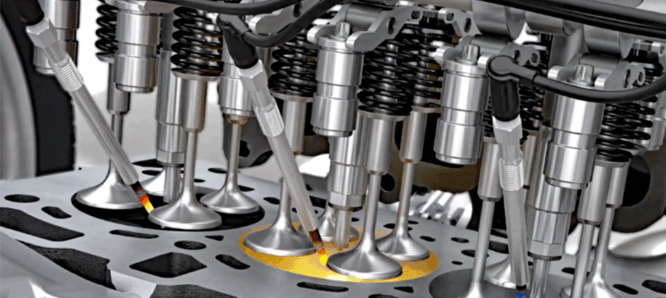 A cutaway diagram of a diesel engine cylinder head showing how glow plugs heat the combustion chambers for a cold start.