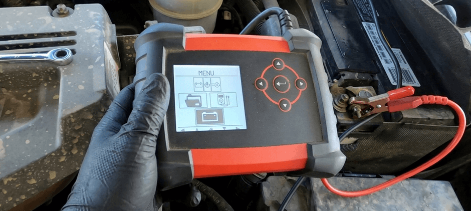 Mechanic performing a load test on a truck battery to diagnose a P2509 code.