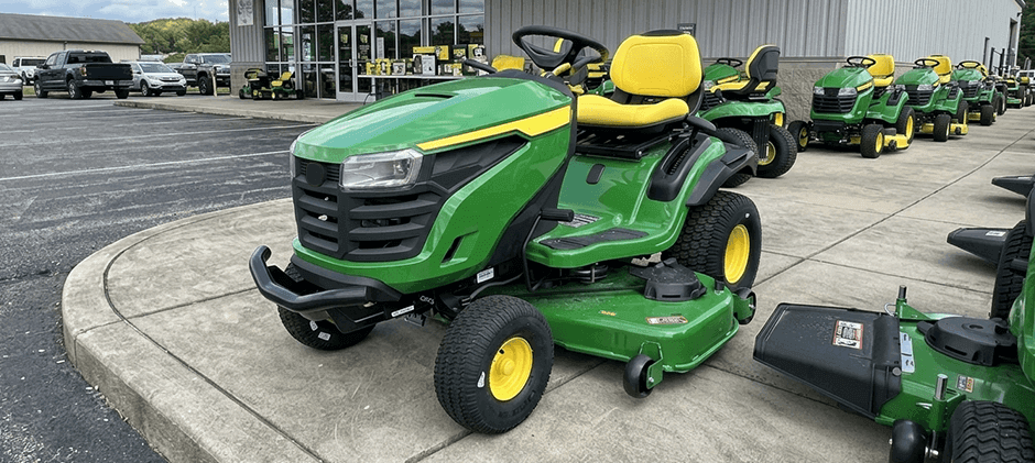 John Deere S240 lawn tractor parked outside a dealership.
