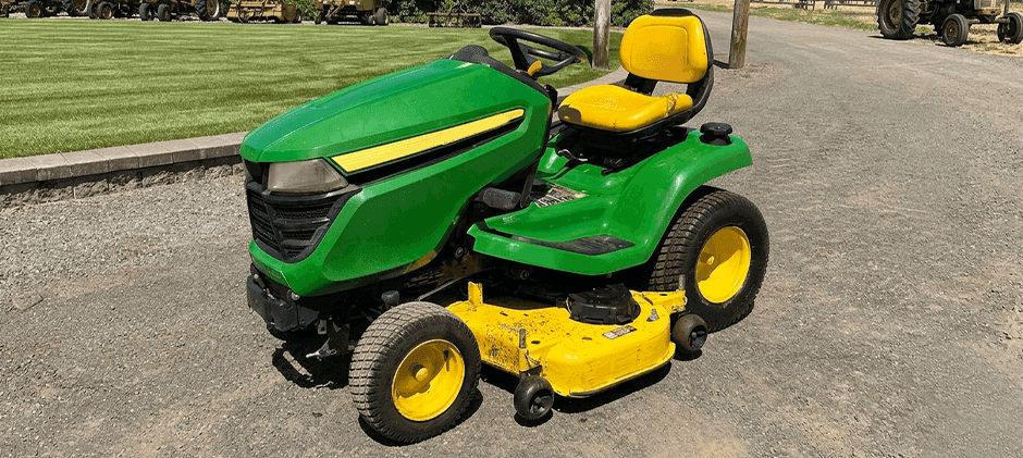 John Deere X380 heavy-duty lawn tractor with a yellow mower deck.